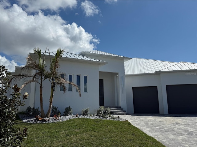 view of front of property with a garage and a front lawn