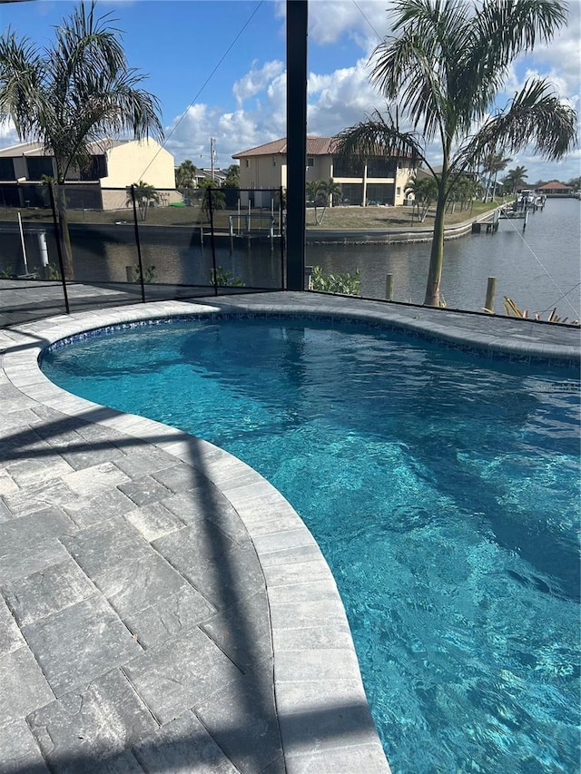 view of pool featuring a water view