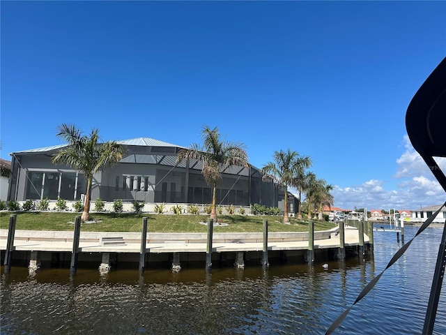 view of dock featuring glass enclosure and a water view