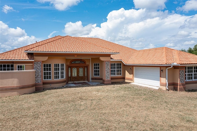 mediterranean / spanish-style house featuring a front lawn, a garage, and french doors