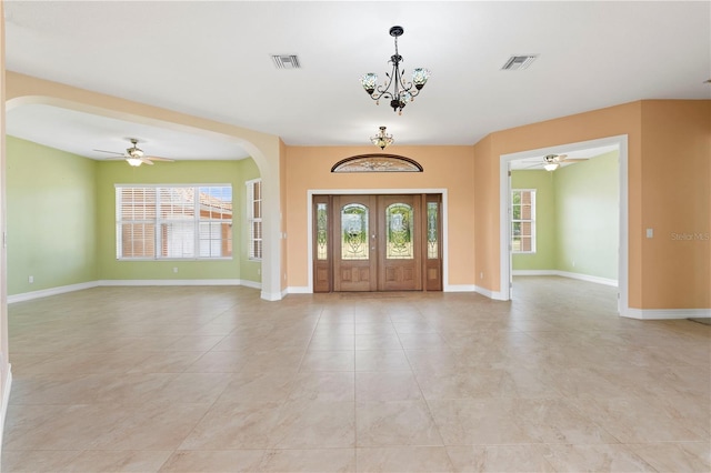 tiled entrance foyer featuring a notable chandelier