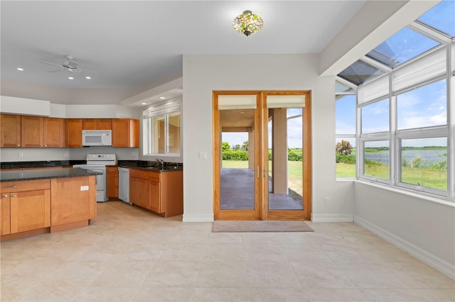 kitchen featuring ceiling fan, white appliances, a wealth of natural light, and french doors