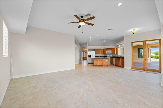 unfurnished living room featuring ceiling fan