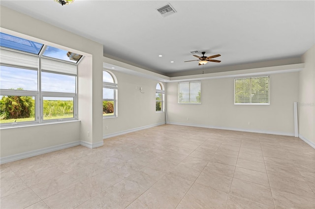 spare room with ceiling fan and light tile patterned flooring