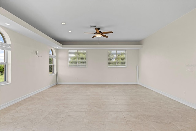 unfurnished room featuring ceiling fan and a healthy amount of sunlight