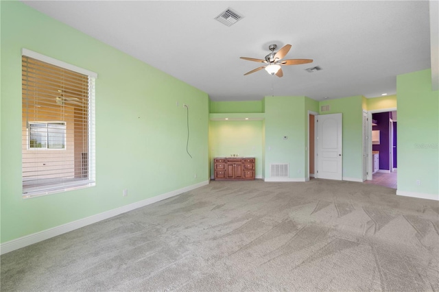 carpeted empty room with ceiling fan