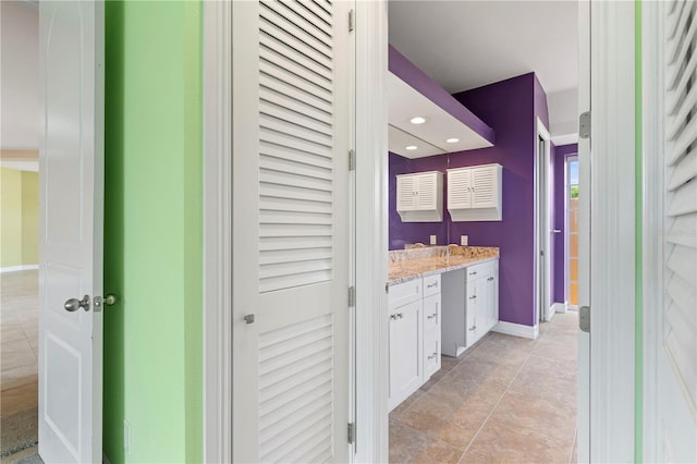 bathroom featuring tile patterned flooring and vanity