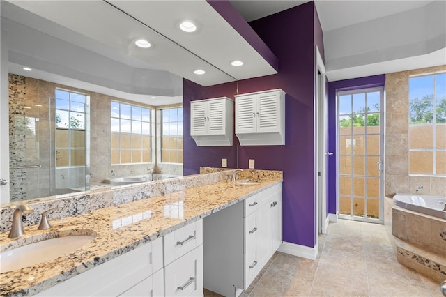 bathroom featuring plus walk in shower, vanity, and tile patterned floors