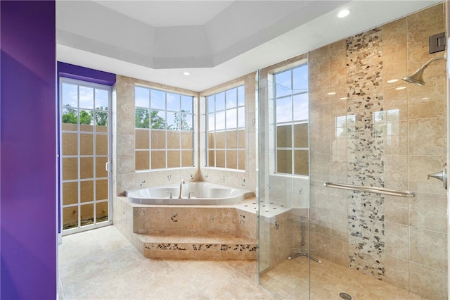 bathroom featuring tile patterned flooring and shower with separate bathtub