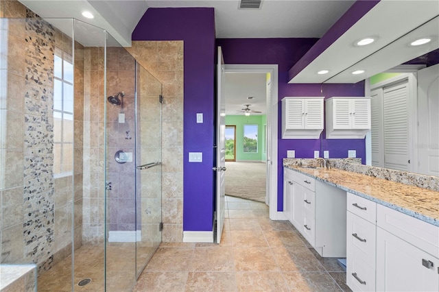 bathroom featuring tile patterned floors, ceiling fan, vanity, and a shower with shower door