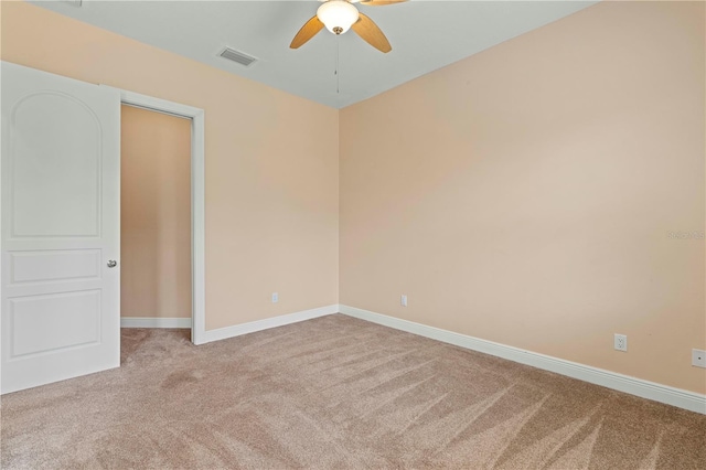 spare room featuring carpet floors and ceiling fan