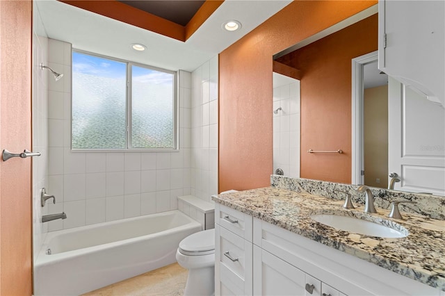 full bathroom with vanity, tile patterned flooring, tiled shower / bath, and toilet