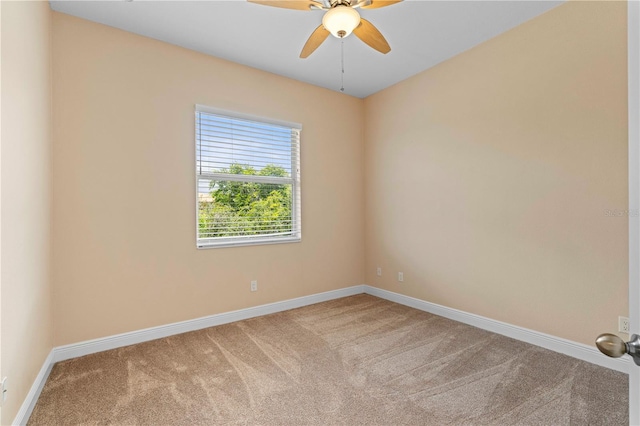 empty room featuring ceiling fan and carpet