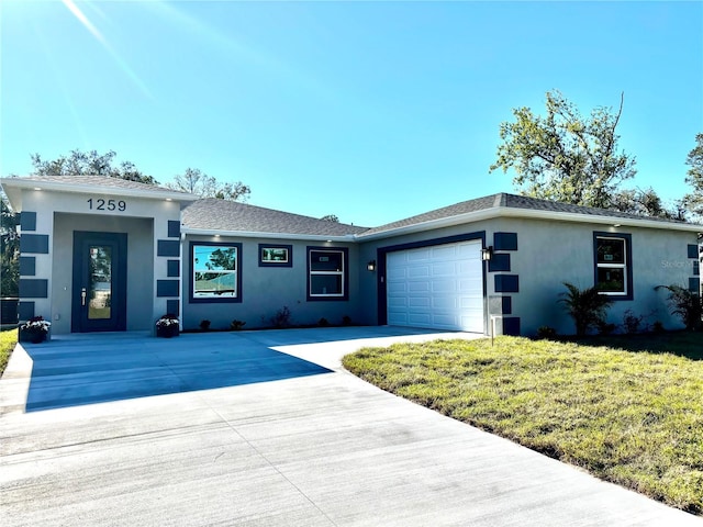 ranch-style house featuring a garage and a front lawn