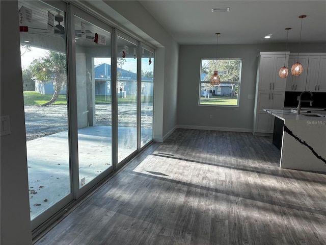 kitchen with sink, dark hardwood / wood-style floors, and decorative light fixtures