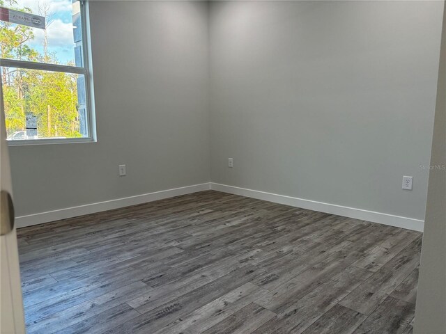 unfurnished room featuring dark hardwood / wood-style floors