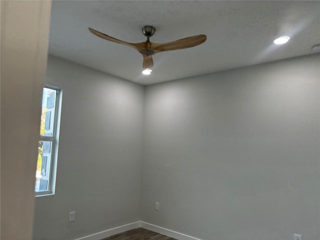 spare room with ceiling fan and dark wood-type flooring