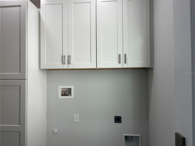 laundry room featuring cabinets, hookup for a washing machine, gas dryer hookup, and hookup for an electric dryer