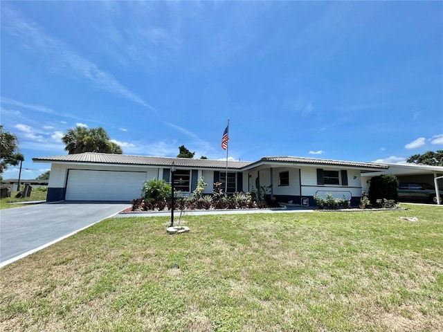 single story home featuring a garage and a front lawn