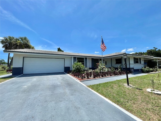 single story home featuring a garage and a front yard