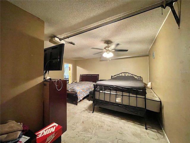 bedroom featuring tile floors, a textured ceiling, and ceiling fan