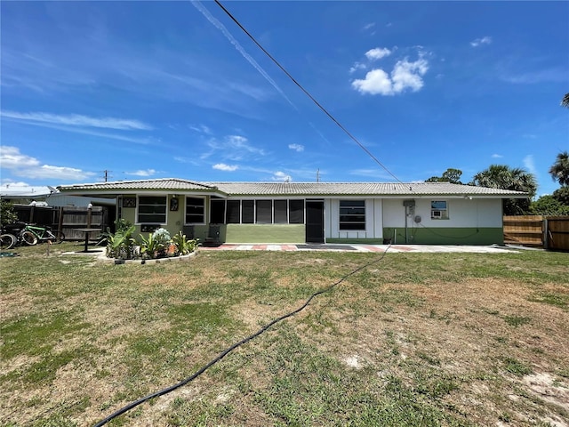 rear view of property with a lawn