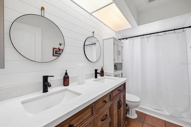 bathroom featuring tile patterned flooring, a shower with curtain, toilet, wood walls, and vanity