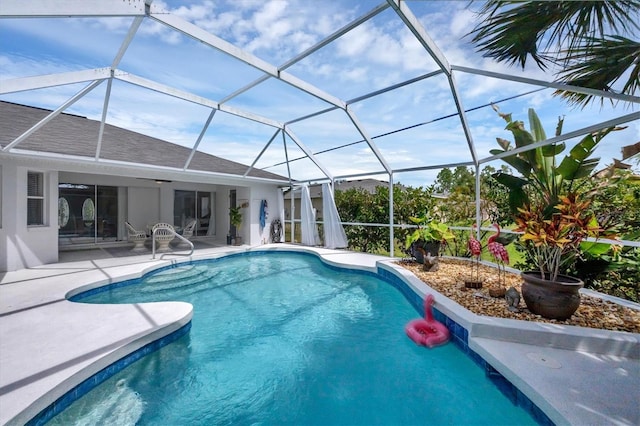 view of pool featuring glass enclosure and a patio area