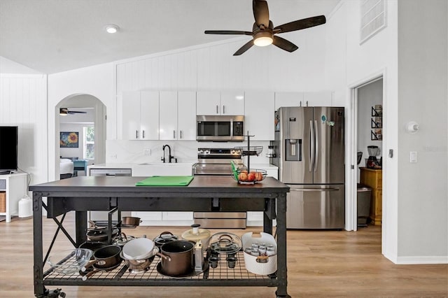 kitchen featuring white cabinetry, appliances with stainless steel finishes, ceiling fan, sink, and light hardwood / wood-style flooring