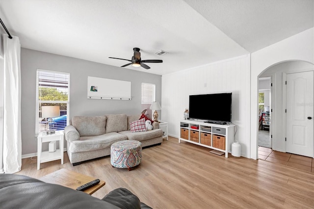 living room with ceiling fan and wood-type flooring