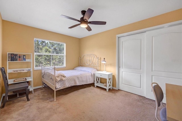 bedroom with a closet, ceiling fan, and light colored carpet