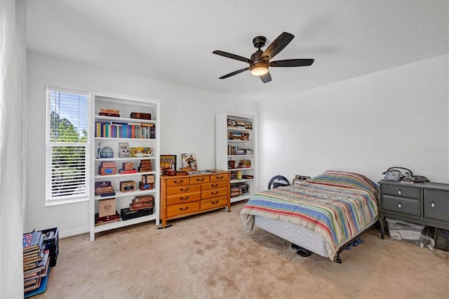 bedroom featuring ceiling fan and light carpet