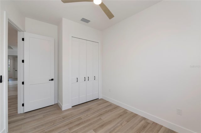 unfurnished bedroom with a closet, ceiling fan, and light wood-type flooring