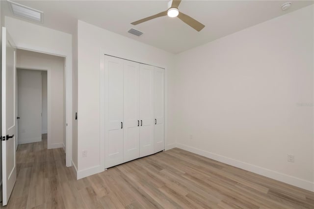 unfurnished bedroom with ceiling fan, a closet, and light hardwood / wood-style floors