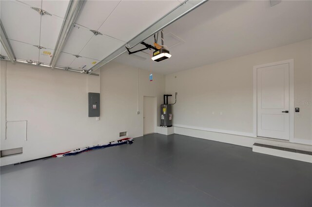 garage with a garage door opener and electric water heater