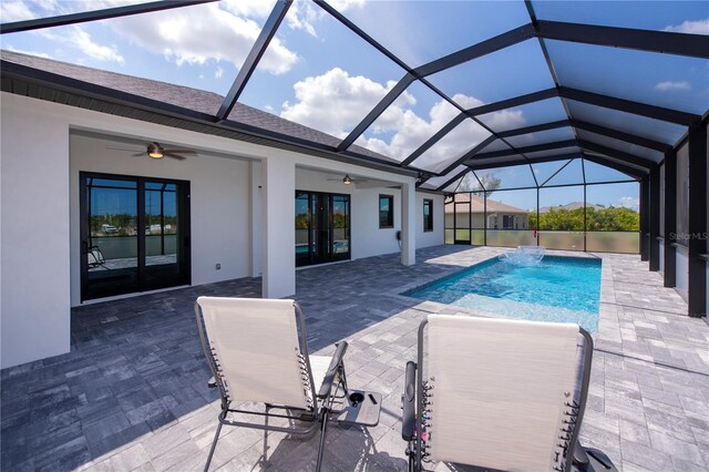 view of swimming pool with a patio, pool water feature, a lanai, and ceiling fan