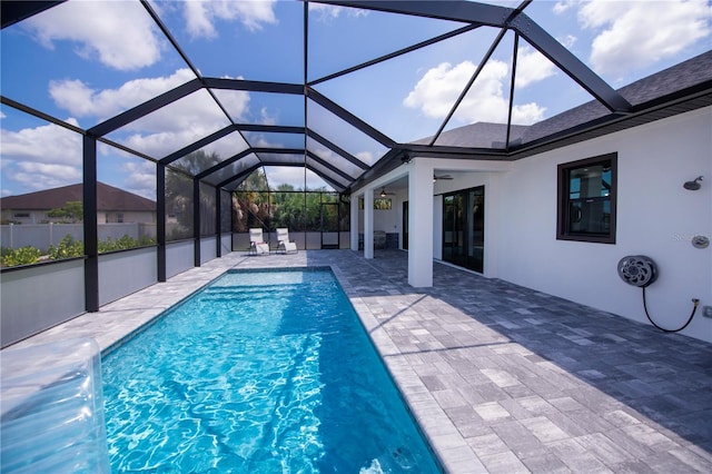 view of swimming pool featuring a lanai and a patio area