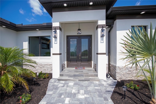 view of exterior entry featuring french doors