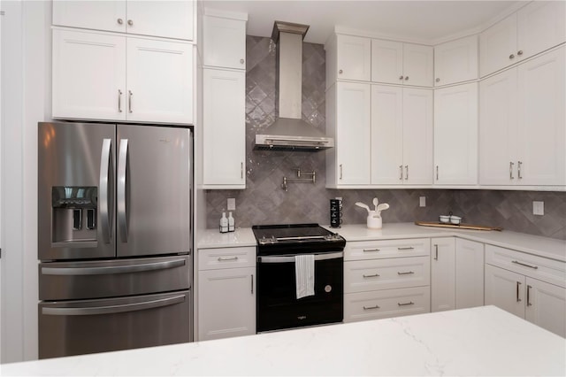 kitchen with stainless steel refrigerator with ice dispenser, white cabinetry, wall chimney exhaust hood, and range with electric stovetop