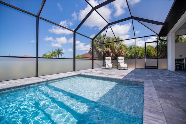 view of swimming pool with a patio and glass enclosure