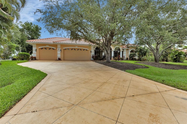 mediterranean / spanish-style house with a front lawn and a garage