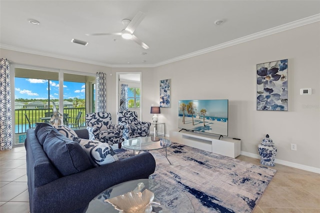 living room featuring ceiling fan, crown molding, and light tile patterned flooring