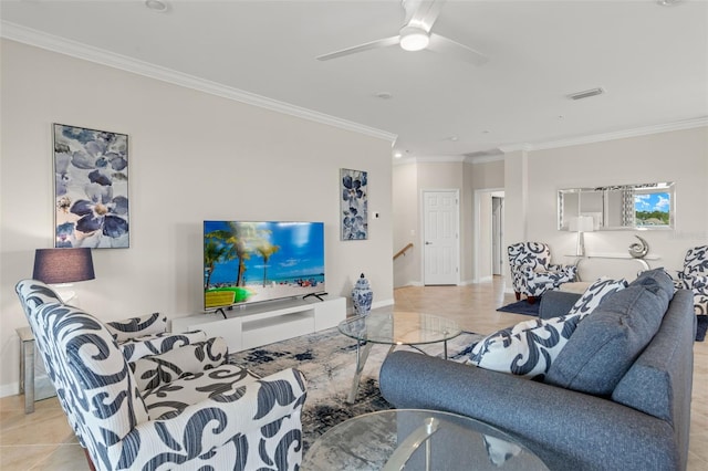 living room with ceiling fan, light tile patterned floors, crown molding, and decorative columns