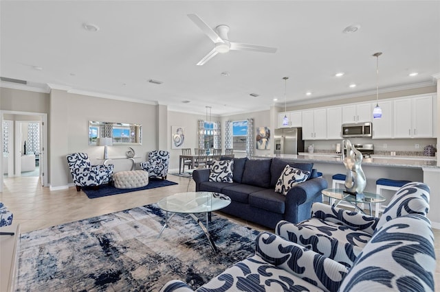 tiled living room with ceiling fan and ornamental molding