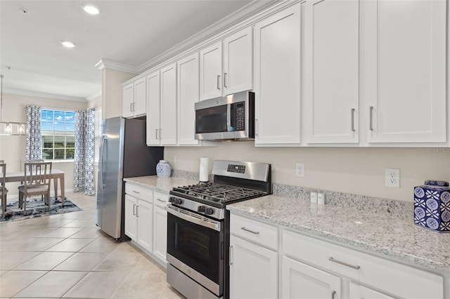 kitchen featuring crown molding, light stone counters, white cabinetry, and stainless steel appliances