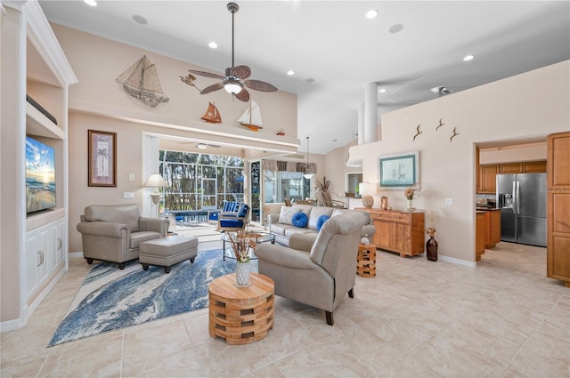 living room featuring ceiling fan and high vaulted ceiling