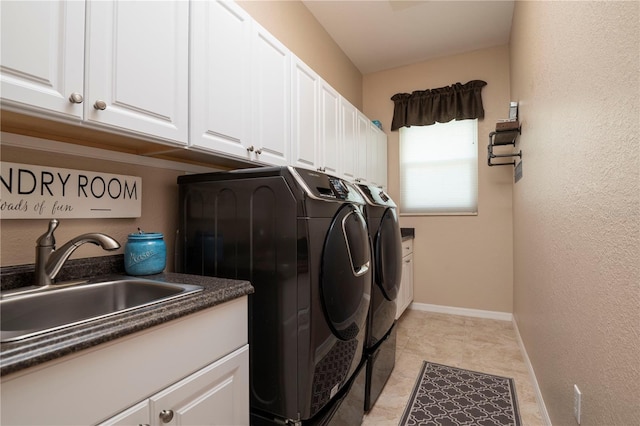 washroom with sink, washing machine and clothes dryer, and cabinets