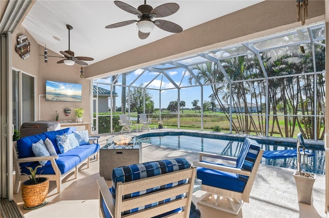 view of pool featuring an outdoor hangout area, ceiling fan, glass enclosure, and a patio area