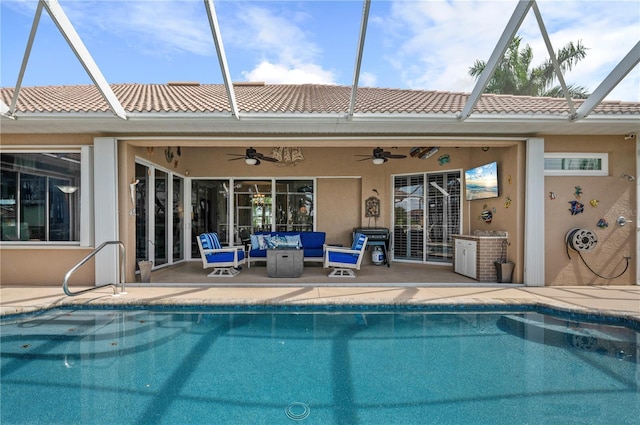 back of house with a lanai, ceiling fan, an outdoor living space, and a patio