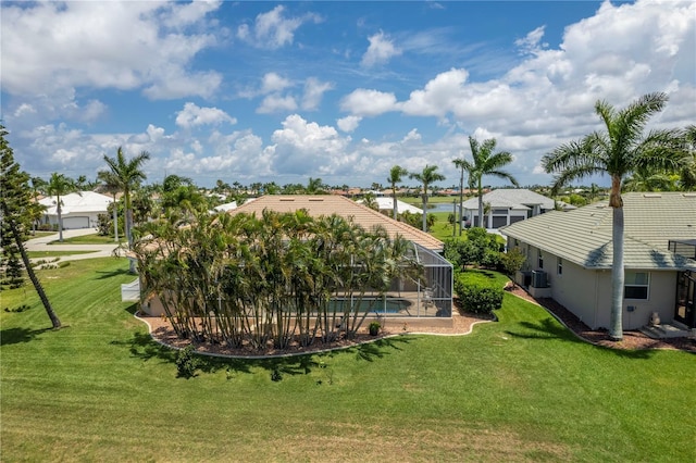 view of yard with a lanai and central AC unit